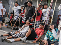 Balinese men carry long wooden sticks and take part in the Mekotek ritual in Munggu Village, Bali, Indonesia, on October 5, 2024. Mekotek is...