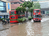 Vehicles and rickshaws drive with passengers through the waterlogged streets of Dhaka, Bangladesh, on October 5, 2024, after heavy rainfalls...