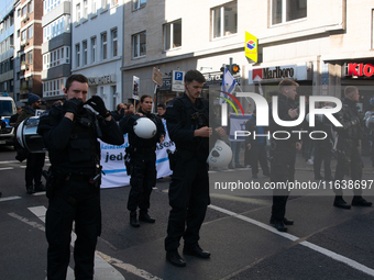 Police block the protesters from pro-Israeli protesters as a thousand protesters take part in a protest demanding a ceasefire and opposing o...