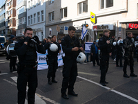 Police block the protesters from pro-Israeli protesters as a thousand protesters take part in a protest demanding a ceasefire and opposing o...