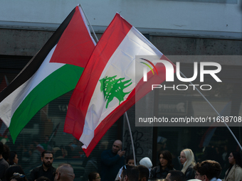 Lebanon and Palestine flags are seen as a thousand protesters take part in a protest demanding a ceasefire and opposing ongoing Israel attac...