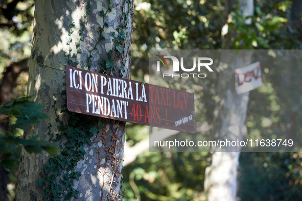 A placard on a tree on the Canal du Midi banks reads 'here, one pays the TGV tax for 40 years'. Zadists, or development protesters, begin to...