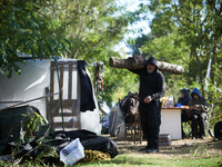 A zadist walks with a trunk to build a hut in a tree. Zadists, or development protesters, begin to install a ZAD (Zone to Defend, a militant...