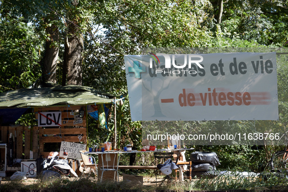 Along the Canal du Midi, near Toulouse, France, on October 4, 2024, zadists display a banner reading 'more trees and more life, less speed'....