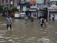 Residents walk through a waterlogged street after heavy rainfall in Dhaka, Bangladesh, on October 5, 2024. The flash flood hits several area...