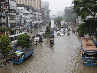 Residents make their way through a waterlogged street after heavy rainfall in Dhaka, Bangladesh, on October 5, 2024. The flash flood hits se...