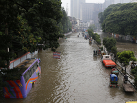 Residents make their way through a waterlogged street after heavy rainfall in Dhaka, Bangladesh, on October 5, 2024. The flash flood hits se...