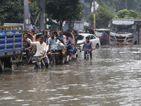 Residents make their way through a waterlogged street after heavy rainfall in Dhaka, Bangladesh, on October 5, 2024. The flash flood hits se...