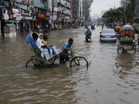 Rickshaw pullers make their way through a waterlogged street during rainfall in Dhaka, Bangladesh, on September 26, 2024. The flash flood hi...