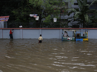 Residents walk through a waterlogged street after heavy rainfall in Dhaka, Bangladesh, on October 5, 2024. The flash flood hits several area...