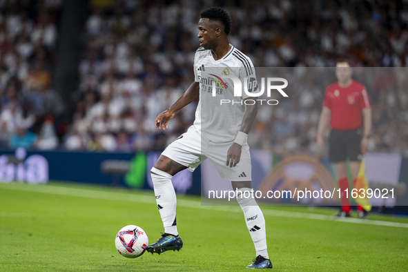 Vinicius Junior of Real Madrid CF is in action with the ball during the La Liga EA Sports 2024/25 football match between Real Madrid CF and...