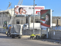 Workers hang billboards bearing a portrait of slain Lebanese Hezbollah Leader Hassan Nasrallah along the airport highway in Beirut, Lebanon,...