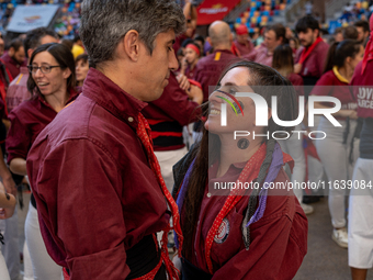 A couple from Colla Castellera Jove de Barcelona participates in the Concurs de Castells competition in Tarragona, Spain, on October 5, 2024...