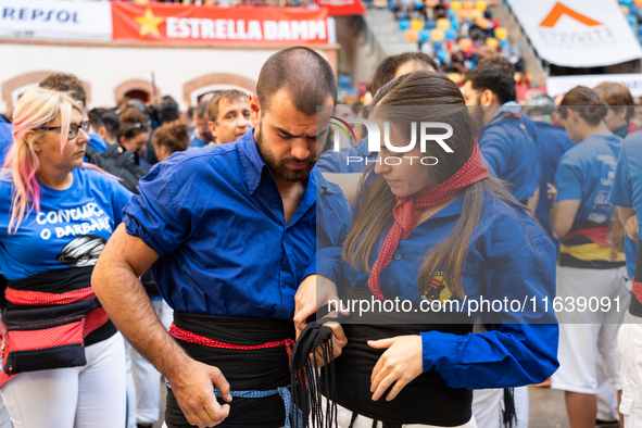 A couple prepares to perform a human tower during the Concurs de Castells competition in Tarragona, Spain, on October 5, 2024. 