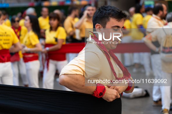 A man prepares for a human tower during the Concurs de Castells competition in Tarragona, Spain, on October 5, 2024. 