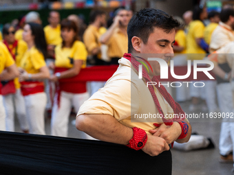 A man prepares for a human tower during the Concurs de Castells competition in Tarragona, Spain, on October 5, 2024. (