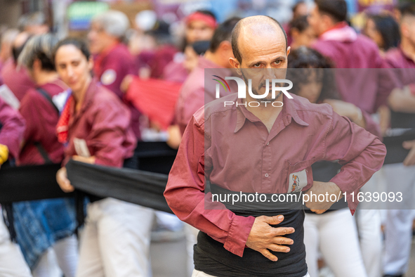 A man prepares for a human tower during the Concurs de Castells competition in Tarragona, Spain, on October 5, 2024. 