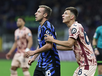 Davide Frattesi and Gvidas Gineitis participate in the Serie A 2024-2025 match between Inter and Torino in Milano, Italy, on October 5, 2024...