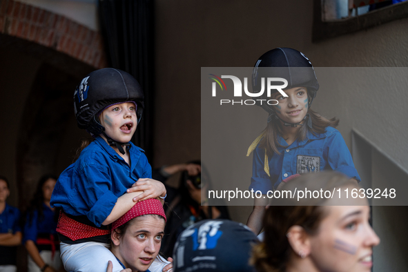 Members of Castellers de la Vila de Gracia participate in the Concurs de Castells competition in Tarragona, Spain, on October 5, 2024. 