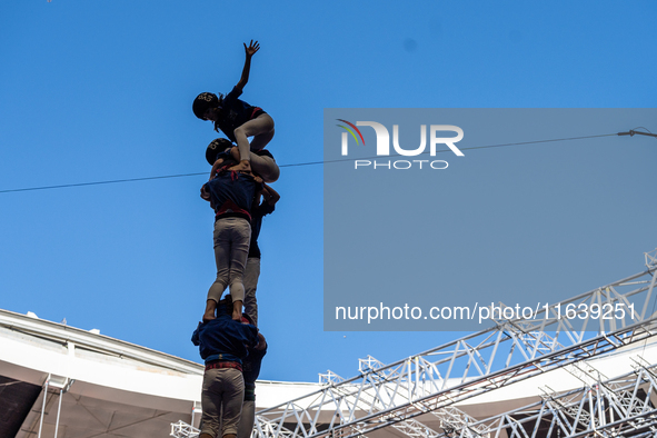 Members of Castellers de la Vila de Gracia participate in the Concurs de Castells competition in Tarragona, Spain, on October 5, 2024. 