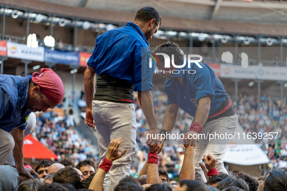 Members of Castellers de la Vila de Gracia participate in the Concurs de Castells competition in Tarragona, Spain, on October 5, 2024. 