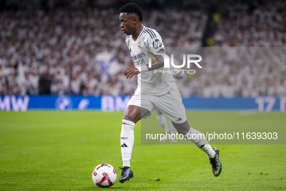 Vinicius Junior of Real Madrid CF is in action with the ball during the La Liga EA Sports 2024/25 football match between Real Madrid CF and...