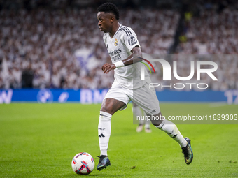 Vinicius Junior of Real Madrid CF is in action with the ball during the La Liga EA Sports 2024/25 football match between Real Madrid CF and...