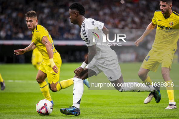 Vinicius Junior of Real Madrid CF is in action with the ball during the La Liga EA Sports 2024/25 football match between Real Madrid CF and...