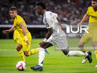 Vinicius Junior of Real Madrid CF is in action with the ball during the La Liga EA Sports 2024/25 football match between Real Madrid CF and...