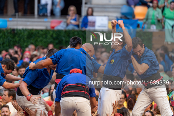 Castellers de Berga celebrates a human castle during the Concurs de Castells competition in Tarragona, Spain, on October 5, 2024. 