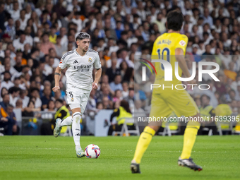 Federico Valverde of Real Madrid CF is in action with the ball during the La Liga EA Sports 2024/25 football match between Real Madrid CF an...