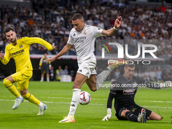 Kylian Mbappe of Real Madrid CF (C) is in action with the ball during the La Liga EA Sports 2024/25 football match between Real Madrid CF an...