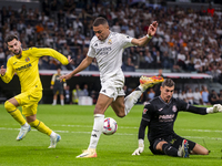 Kylian Mbappe of Real Madrid CF (C) is in action with the ball during the La Liga EA Sports 2024/25 football match between Real Madrid CF an...