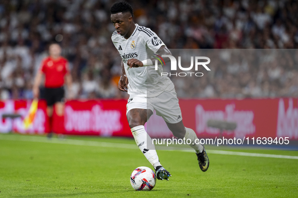 Vinicius Junior of Real Madrid CF is in action with the ball during the La Liga EA Sports 2024/25 football match between Real Madrid CF and...