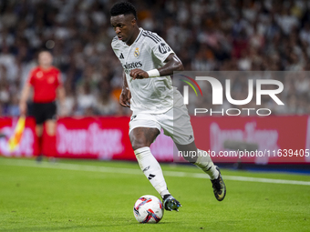 Vinicius Junior of Real Madrid CF is in action with the ball during the La Liga EA Sports 2024/25 football match between Real Madrid CF and...