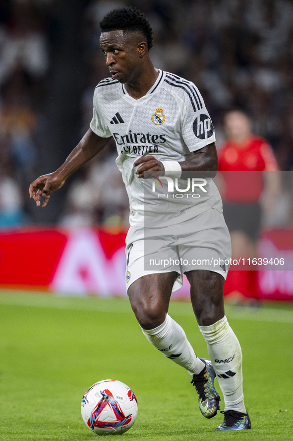 Vinicius Junior of Real Madrid CF is in action with the ball during the La Liga EA Sports 2024/25 football match between Real Madrid CF and...