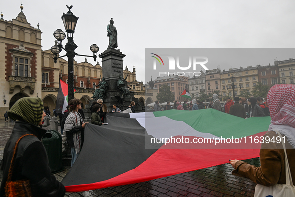 KRAKOW, POLAND - OCTOBER 5:
Pro-Palestinian activists gather in Krakow's UNESCO-listed Old Town for the 'March for Palestine,' calling for a...