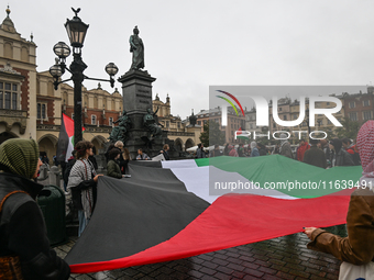 KRAKOW, POLAND - OCTOBER 5:
Pro-Palestinian activists gather in Krakow's UNESCO-listed Old Town for the 'March for Palestine,' calling for a...