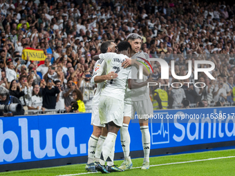 Vinicius Junior of Real Madrid CF celebrates his goal with his teammates Daniel Carvajal (L) and Federico Valverde (R) during the La Liga EA...