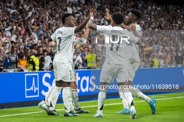 Vinicius Junior of Real Madrid CF celebrates his goal with his teammates Rodrygo Silva de Goes and Aurelien Tchouameni during the La Liga EA...