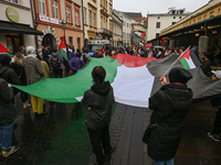 KRAKOW, POLAND - OCTOBER 5:
Pro-Palestinian activists gathered in front of the American Consulate in Krakow's UNESCO-listed Old Town during...