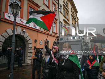 KRAKOW, POLAND - OCTOBER 5:
Pro-Palestinian activists gathered in front of the American Consulate in Krakow's UNESCO-listed Old Town during...