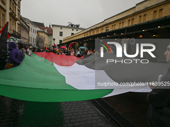 KRAKOW, POLAND - OCTOBER 5:
Pro-Palestinian activists gathered in front of the American Consulate in Krakow's UNESCO-listed Old Town during...