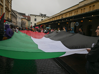 KRAKOW, POLAND - OCTOBER 5:
Pro-Palestinian activists gathered in front of the American Consulate in Krakow's UNESCO-listed Old Town during...