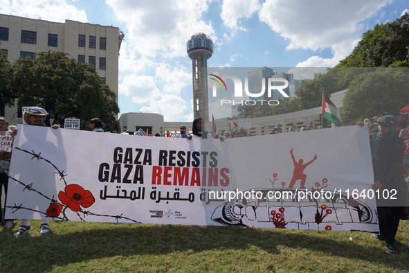 Hundreds of people join a demonstration in solidarity with the Palestinian people at The Grassy Knoll to mark the first anniversary of the w...