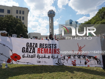 Hundreds of people join a demonstration in solidarity with the Palestinian people at The Grassy Knoll to mark the first anniversary of the w...