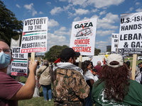 Hundreds of people join a demonstration in solidarity with the Palestinian people at The Grassy Knoll to mark the first anniversary of the w...