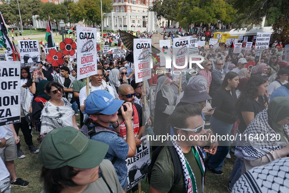 Hundreds of people join a demonstration in solidarity with the Palestinian people at The Grassy Knoll to mark the first anniversary of the w...