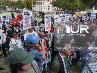 Hundreds of people join a demonstration in solidarity with the Palestinian people at The Grassy Knoll to mark the first anniversary of the w...