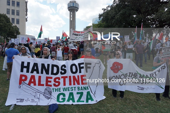 Hundreds of people join a demonstration in solidarity with the Palestinian people at The Grassy Knoll to mark the first anniversary of the w...